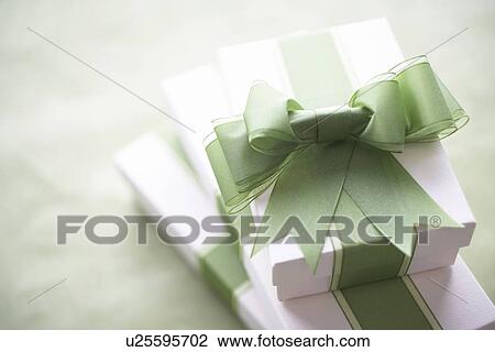 Stock Image - Gifts with green ribbons. Fotosearch