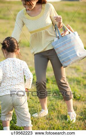 Girl and woman in field View Large Photo Image Stock Image - Girl and woman in field. Fotosearch