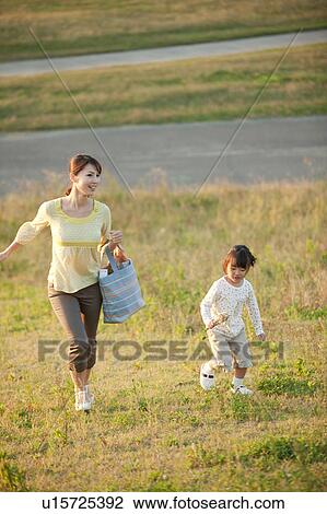 Girl and woman running at riverbank View Large Photo Image Stock Image - Girl and woman running at riverbank. Fotosearch