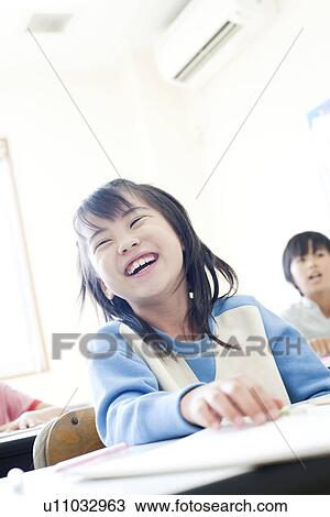Stock Image - Girl at cram school smiling. Fotosearch