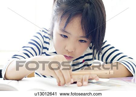 Girl at cram school using an eraser View Large Photo Image Stock Image - Girl at cram school using an eraser. Fotosearch