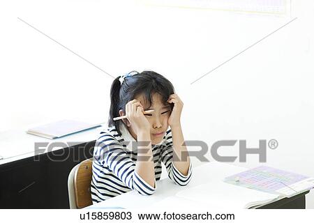 Stock Image - Girl frustrated at cram school. Fotosearch
