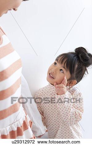 Girl holding mother's hand, looking up, white background View Large Photo Image Stock Image - Girl holding mother's hand, looking up, white background. Fotosearch