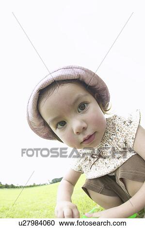 Stock Image - Girl looking at a camera. Fotosearch