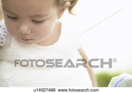 Girl looking down View Large Photo Image Stock Photo - Girl looking down. Fotosearch