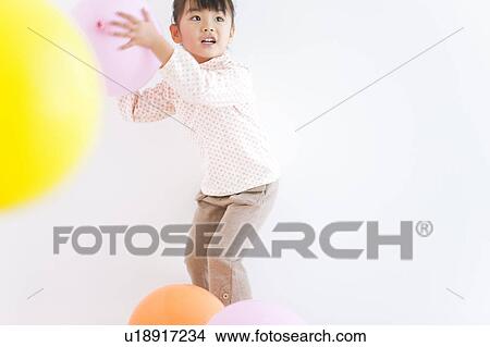 Girl playing with balloons, white background View Large Photo Image Picture - Girl playing with balloons, white background. Fotosearch