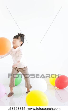 Girl playing with balloons, white background View Large Photo Image Stock Photography - Girl playing with balloons, white background. Fotosearch