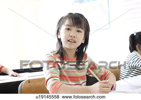 Stock Photo - Girl studying at cram school. Fotosearch