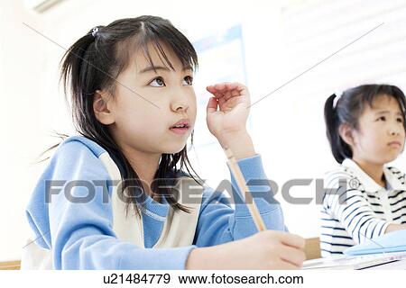 Stock Photo - Girl studying at cram school. Fotosearch