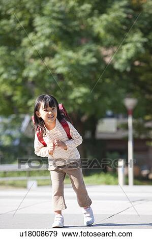 Girl with backpack at street, smiling View Large Photo Image Stock Photo - Girl with backpack at street, smiling. Fotosearch