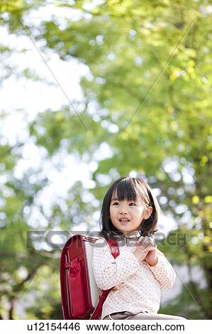 Girl with backpack looking away View Large Photo Image Stock Photograph - Girl with backpack looking away. Fotosearch