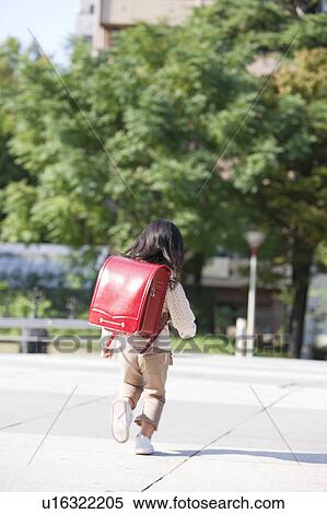 Stock Photography - Girl with backpack running. Fotosearch