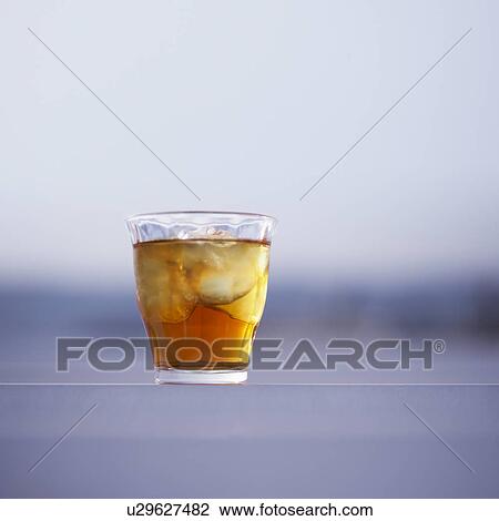 Stock Image - Glass of iced tea, differential focus. Fotosearch