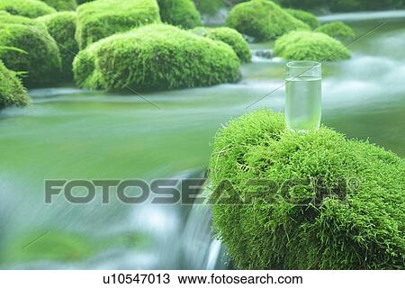Glass of water on mossy stone by stream View Large Photo Image Stock Image - Glass of water on mossy stone by stream. Fotosearch