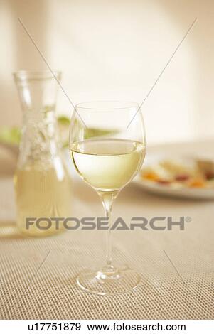 Glass of white wine on table View Large Photo Image Stock Photo - Glass of white wine on table. Fotosearch