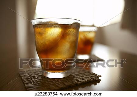 Picture - Glasses of iced tea on table, close up, differential focus. Fotosearch