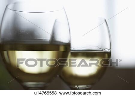 Glasses of white wine, close up, differential focus View Large Photo Image Stock Photo - Glasses of white wine, close up, differential focus. Fotosearch