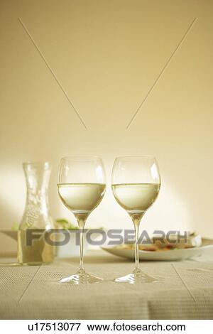 Glasses of white wine on table View Large Photo Image Stock Photo - Glasses of white wine on table. Fotosearch