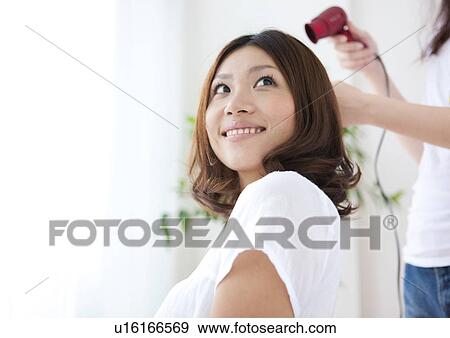 Hairdresser drying woman's hair View Large Photo Image Stock Photo - Hairdresser drying woman's hair. Fotosearch