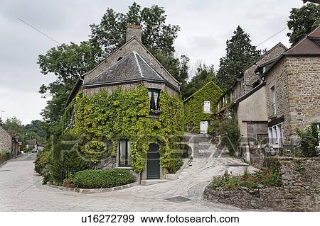 Stock Photo - House Stands at Fork in the Road, Ivied, Norman die, France. Fotosearch