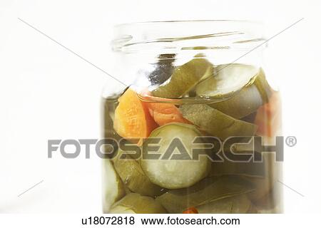 Stock Photo - Jar of pickled vegetables, close up, white background. Fotosearch