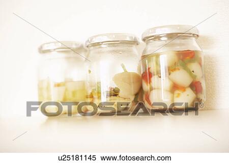 Stock Photography - Jars of pickled vegetables, white background. Fotosearch