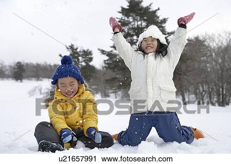 Stock Image - Kids playing in snow. Fotosearch