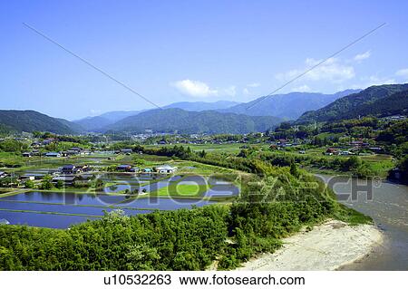Stock Image - Kiso river and rice paddies. Fotosearch
