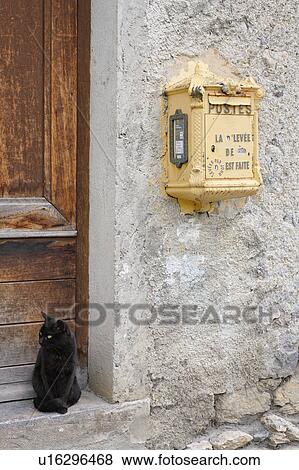 Letter Box on Wall and Black Cat Sitting at Door, Midi Pyrenees, France View Large Photo Image Stock Photo - Letter Box on Wall and Black Cat Sitting at Door, Midi Pyrenees, France. Fotosearch