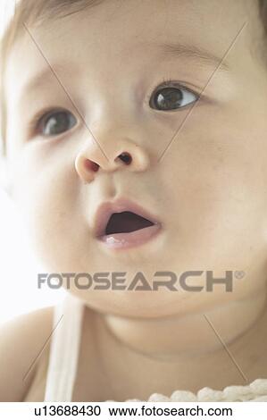 Stock Image - Low angle view of baby girl. Fotosearch