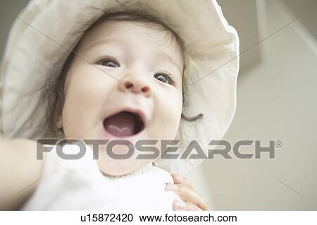Stock Image - Low angle view of baby girl. Fotosearch