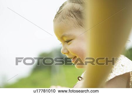 Low angle view of girl looking down over rope View Large Photo Image Stock Image - Low angle view of girl looking down over rope. Fotosearch