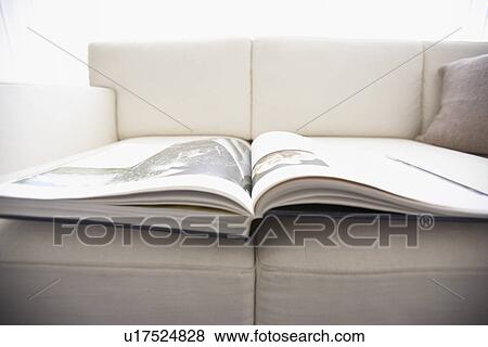 Stock Photo - Magazine on sofa, close up. Fotosearch