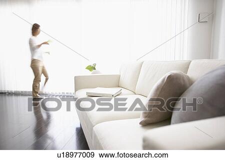 Man in living room, blurred motion, Tokyo prefecture, Japan View Large Photo Image Stock Photo - Man in living room, blurred motion, Tokyo prefecture, Japan. Fotosearch