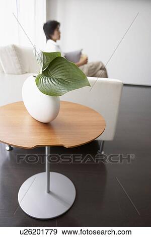 Man in living room, sitting on sofa View Large Photo Image Stock Photo - Man in living room, sitting on sofa. Fotosearch