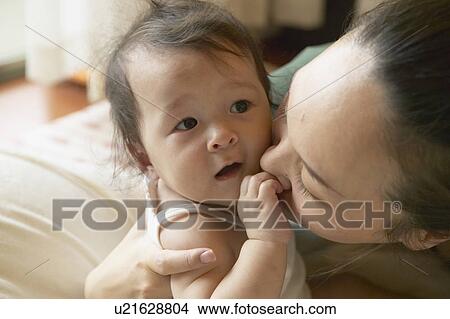 Mother kissing baby View Large Photo Image Picture - Mother kissing baby. Fotosearch