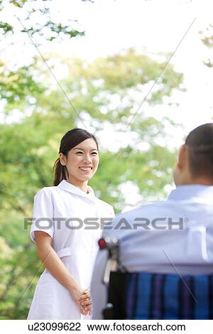 Nurse and man on wheelchair View Large Photo Image Stock Image - Nurse and man on wheelchair. Fotosearch