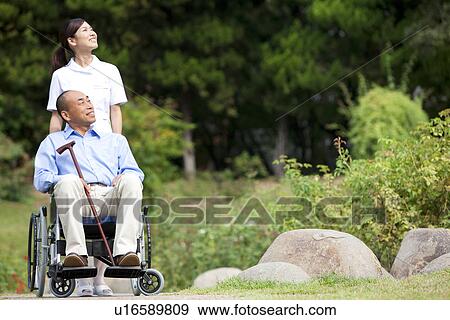 Nurse and man on wheelchair View Large Photo Image Stock Photo - Nurse and man on wheelchair. Fotosearch