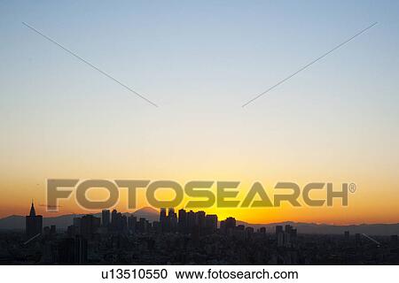 Stock Image - Office buildings and Mt. Fuji in the evening. Fotosearch