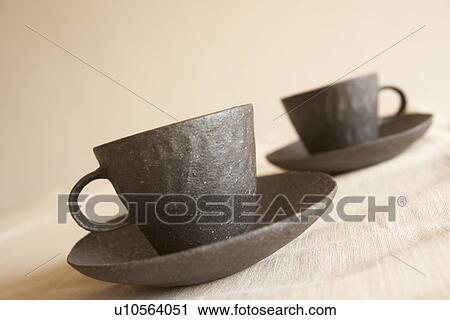 Stock Image - Pair of coffee cups and saucers, close up. Fotosearch