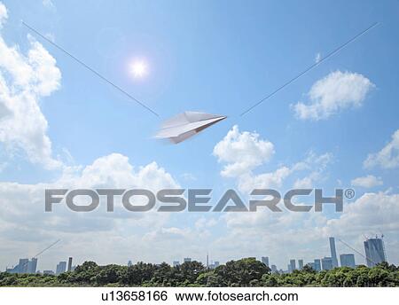 Stock Photograph - Paper airplane flying and Tokyo skyline. Fotosearch