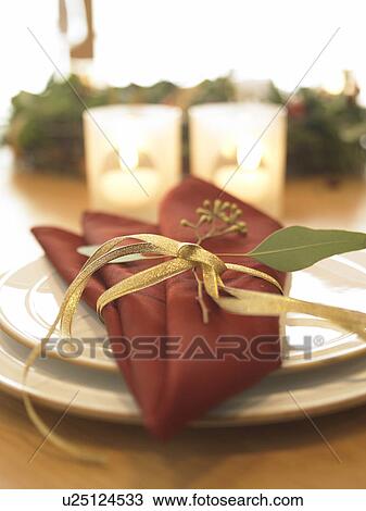 Stock Image - Place settings and burning candles, close up, differential focus. Fotosearch