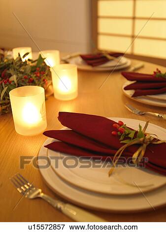 Stock Photo - Place settings and burning candles, long exposure. Fotosearch