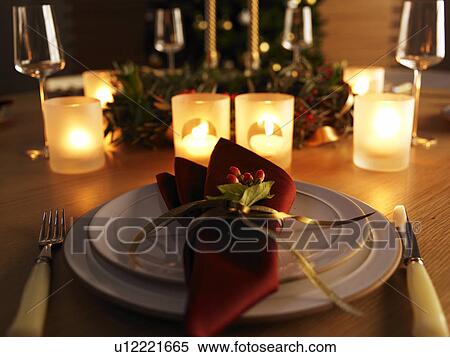 Stock Photography - Place settings and burning candles, long exposure. Fotosearch