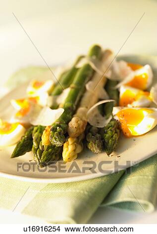 Picture - Plate of asparagus and egg, close up. Fotosearch