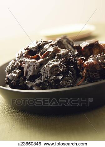 Stock Photograph - Plate of braised beef, close up. Fotosearch