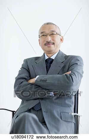 Portrait of businessman with arms crossed, white background View Large Photo Image Stock Image - Portrait of businessman with arms crossed, white background. Fotosearch