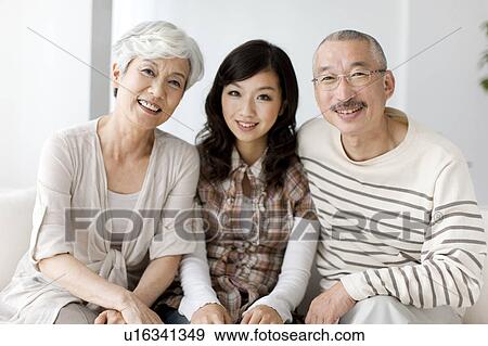 Portrait of family sitting on sofa, smiling View Large Photo Image Stock Photo - Portrait of family sitting on sofa, smiling. Fotosearch