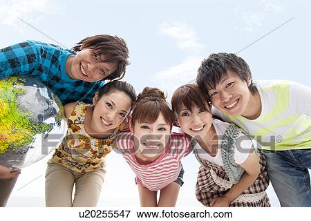 Portrait of five young people in huddle, smiling View Large Photo Image Stock Photo - Portrait of five young people in huddle, smiling. Fotosearch