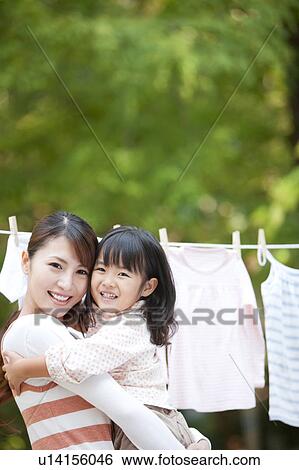 Portrait of girl and woman, woman holding daughter, smiling View Large Photo Image Stock Photograph - Portrait of girl and woman, woman holding daughter, smiling. Fotosearch